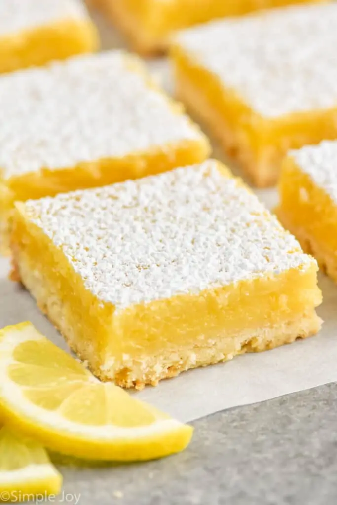 a close up of a lemon bar on parchment paper 