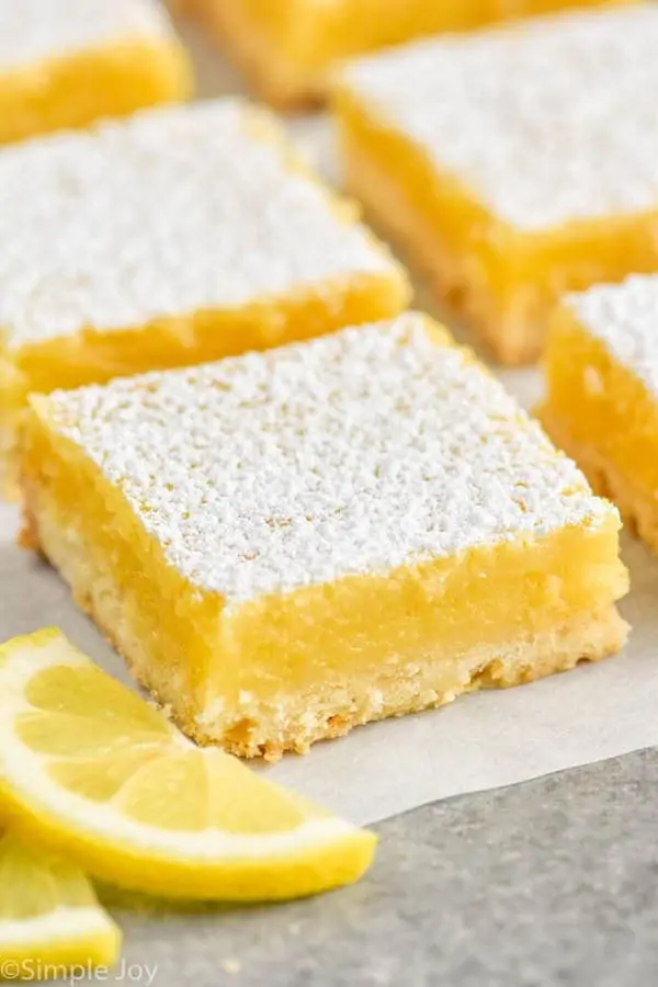 a close up of a lemon bar on parchment paper