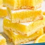 Pinterest graphic of four lemon bars stacked with a bite missing out of the top one