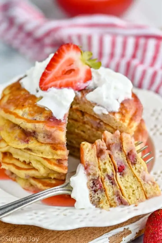 strawberry pancake recipe with a bite cut out and on a fork