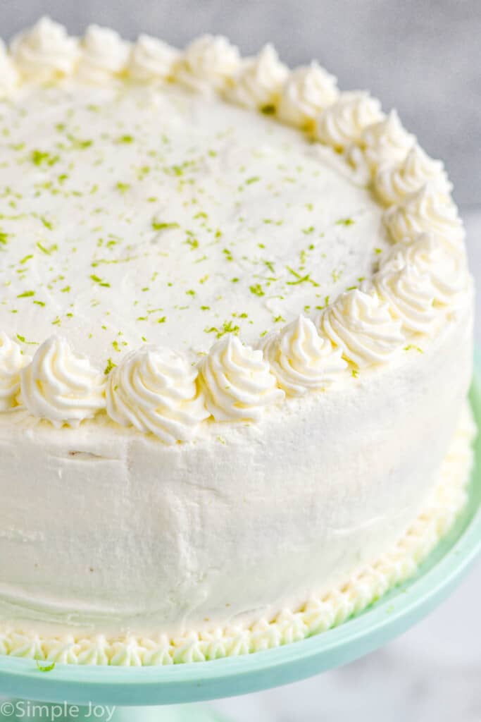 close up of a white cake that is covered in lime zest