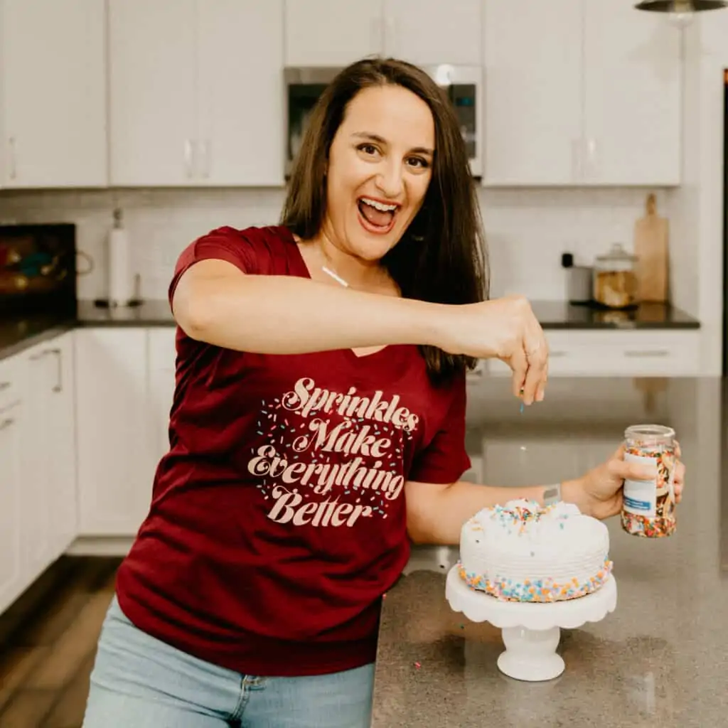 woman in a v-neck shirt that says "sprinkles make everything better"