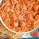 pinterest graphic of overhead of a chicken meatballs in a bowl with spaghetti, sauce covering all of it