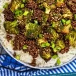 pinterest graphic of overhead of ground beef and broccoli recipe in a bowl over rice