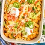 pinterest graphic of overhead of a casserole dish of walking taco casserole