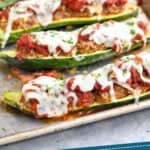 Pinterest graphic of zucchini boats recipes on a rimmed baking sheet