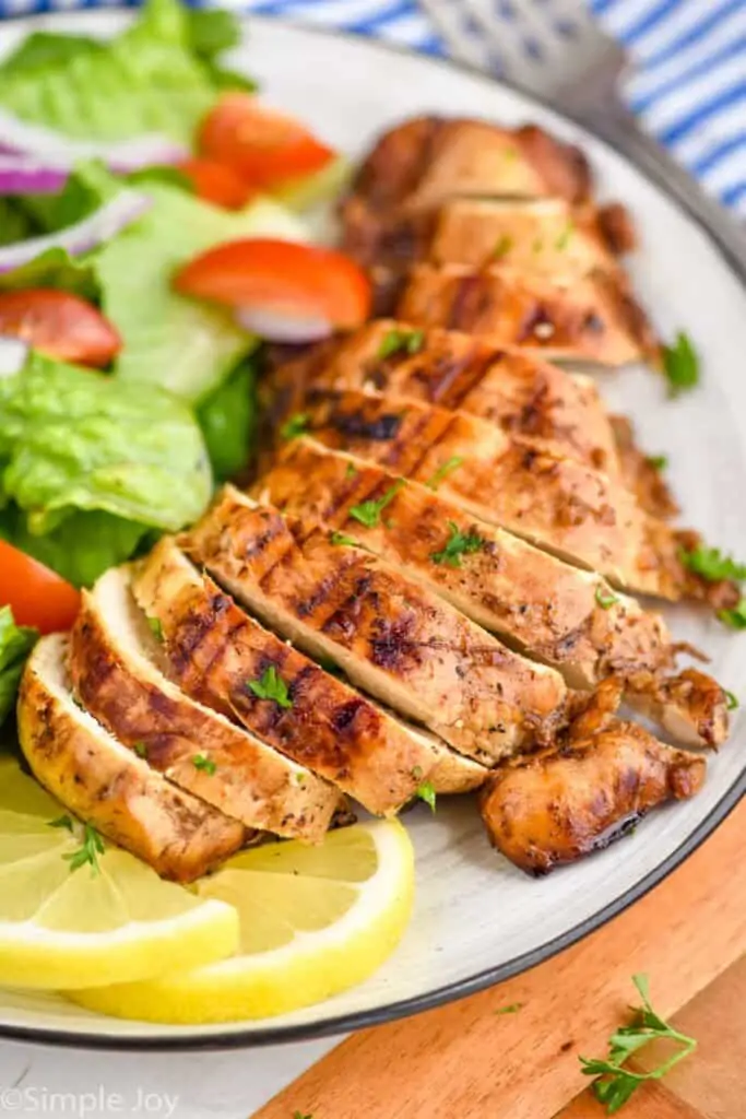 cut up marinated chicken on a plate
