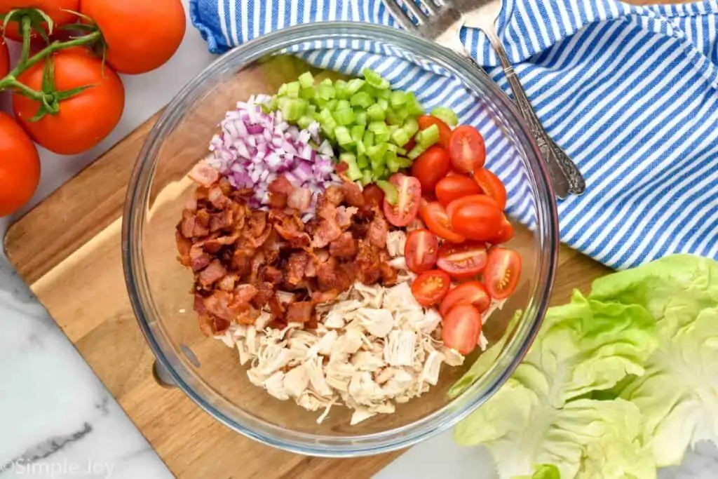 overhead of a bowl with the ingredients for blt chicken salad