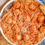 overhead of a chicken meatballs in a bowl with spaghetti, sauce covering all of it - 11