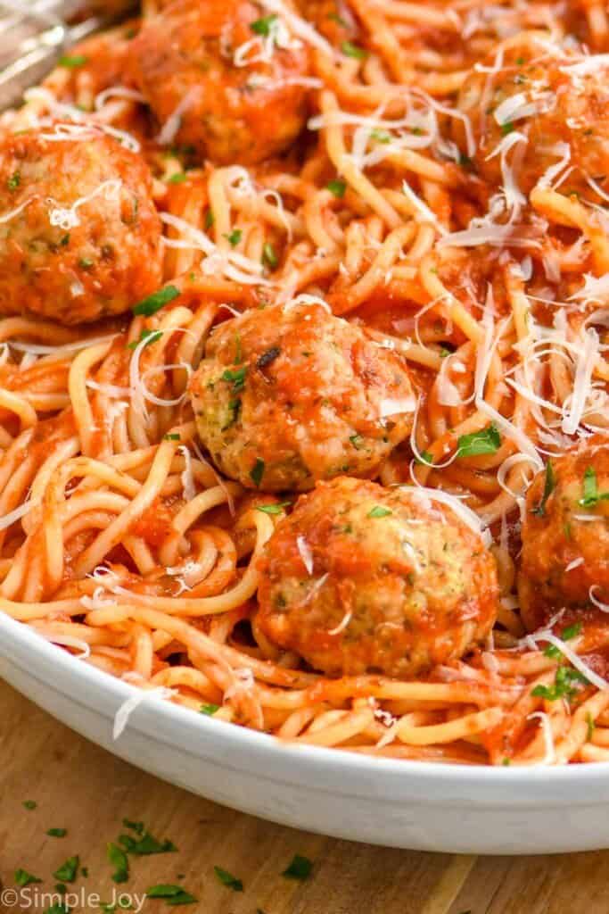 close up of a chicken meatball in a bowl with spaghetti
