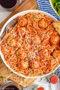 overhead of a chicken meatballs in a bowl with spaghetti, sauce covering all of it