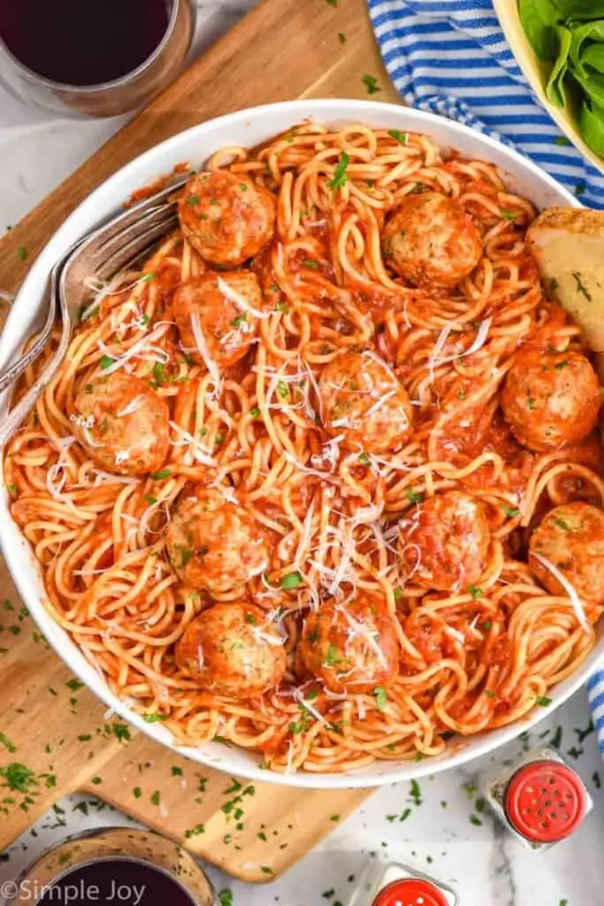 overhead of a chicken meatballs in a bowl with spaghetti, sauce covering all of it