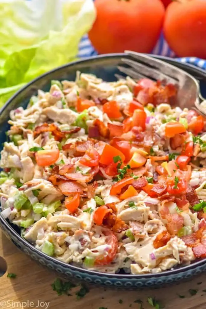 a bowl of chicken salad with bacon