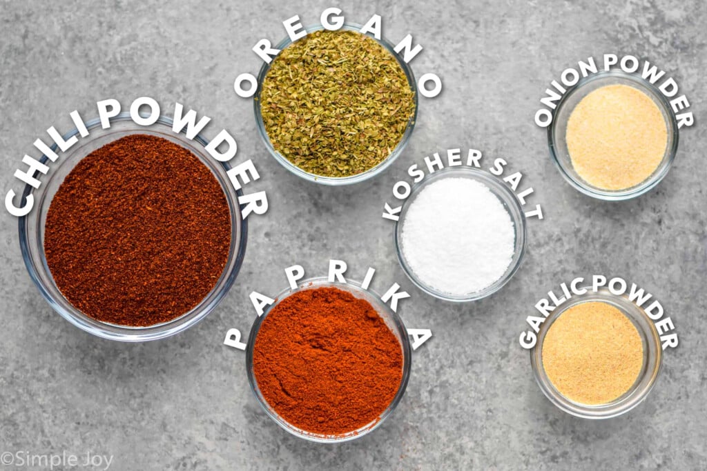 ingredients for fajita seasoning broken up in small bowls and labeled, "chili powder, oregano, paprika, kosher salt, onion, powder, and garlic powder"