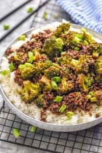 side view of a bowl of ground beef and broccoli over rice