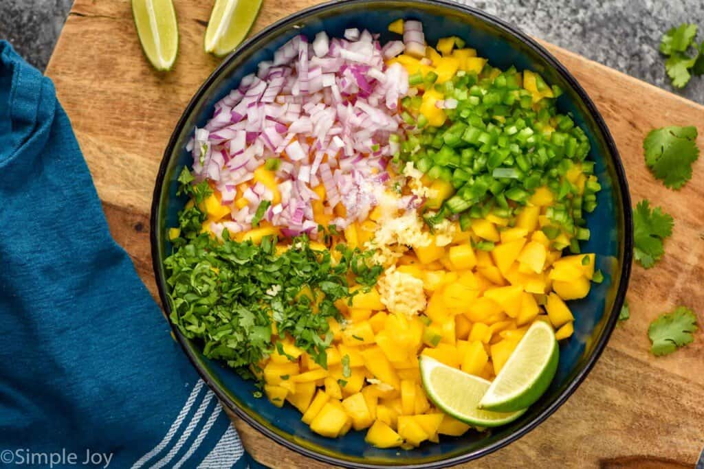 overhead of a bowl of the ingredients to make mango salsa