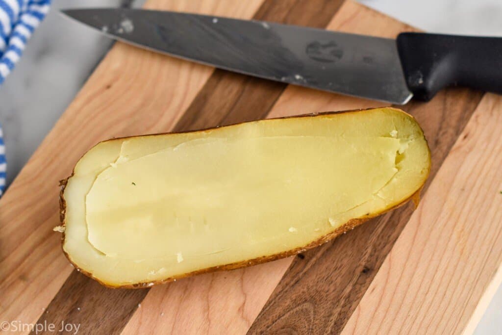 a potato that has been cut in half and the edge scored with a knife to easily get out the insides