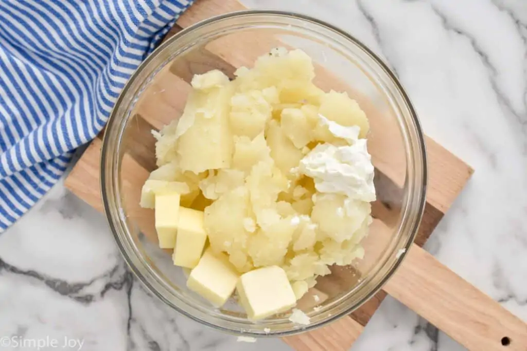 potato filling, sour cream, and butter in a bowl to make easy twice baked potatoes