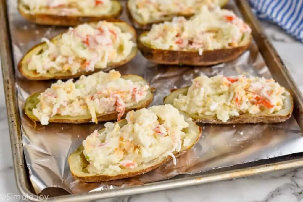 twice baked potatoes stuffed and ready to go back in the oven