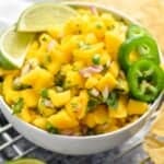 a small white bowl full of mango salsa - 13