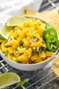 a small white bowl full of mango salsa