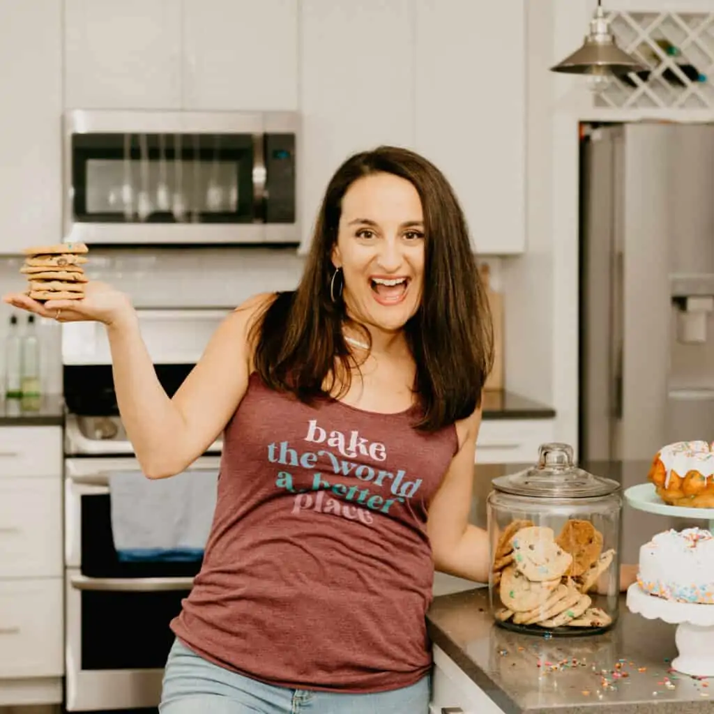 woman in a racer back tank that says "bake the world a better place"