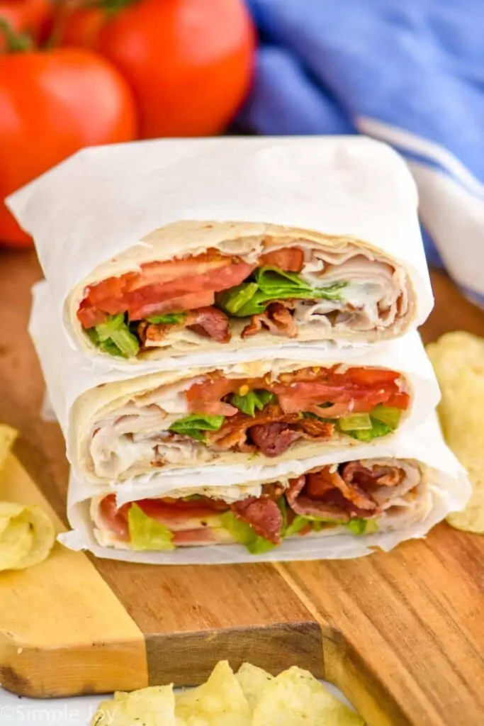 a pile of three blt wraps that have been cut in half