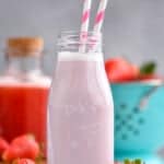 a small milk bottle filled with strawberry milk and two straws - 7