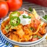 walking taco casserole recipe on two small white plates - 9