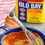 pinterst graphic of small blue dish with old bay seasoning substitute being mixed together with a small whisk