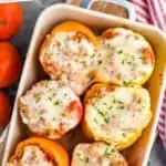 Pinterest graphic of overhead of six stuffed peppers in a baking dish