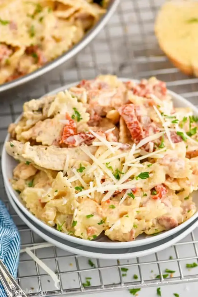 creamy sun-dried tomato pasta on small white plates