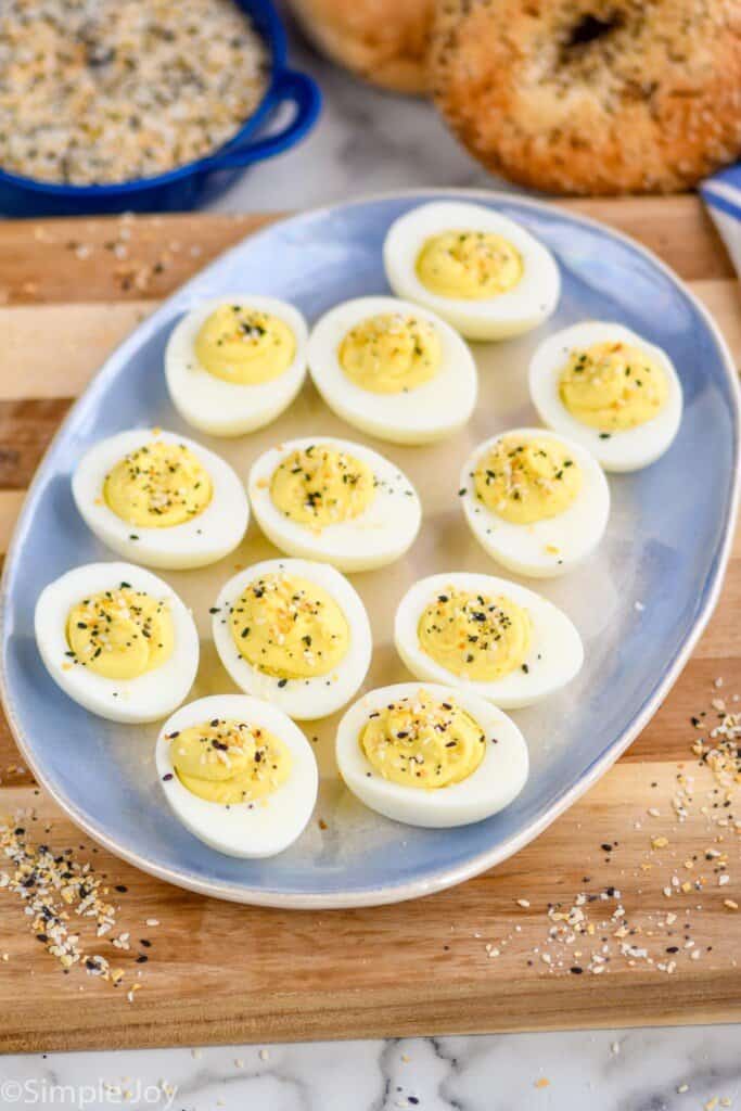 everything bagel deviled eggs on a blue platter