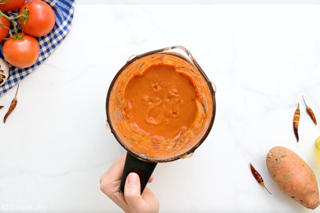 overhead of blender of homemade enchilada sauce to make black bean enchiladas - 6
