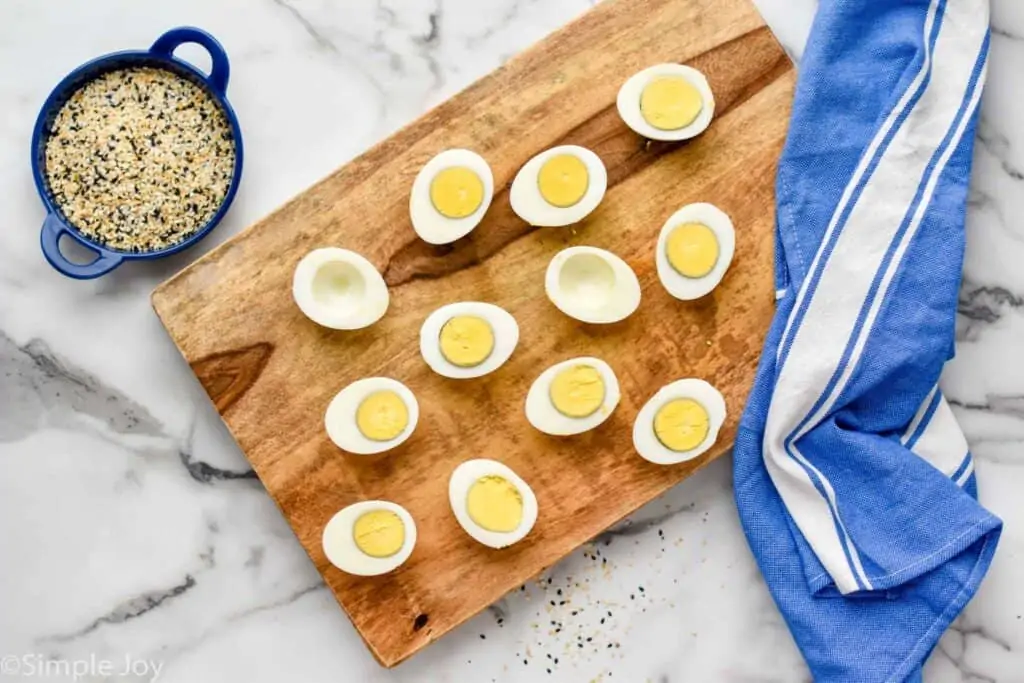 overhead of hard boiled eggs cut in half to make deviled eggs