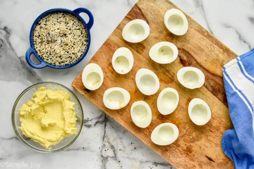 overhead of hard boiled eggs with yolks removed to make deviled eggs recipe