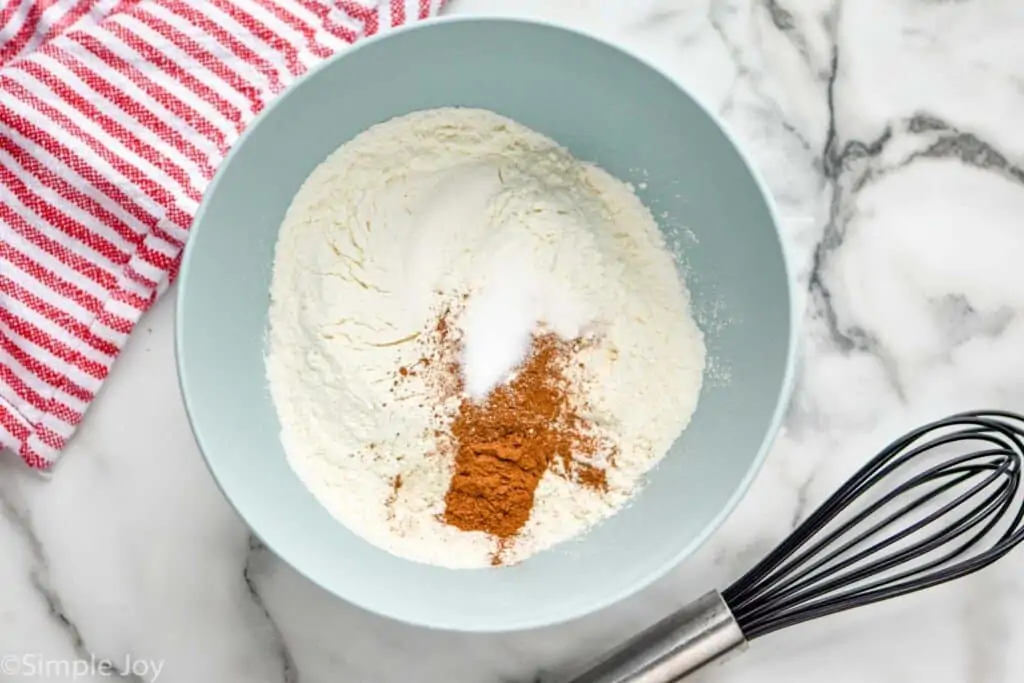 overhead of a bowl of dry ingredients to make oatmeal scotchies