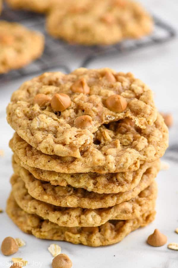 a pile of oatmeal butterscotch cookies with a bite taken out of the top one