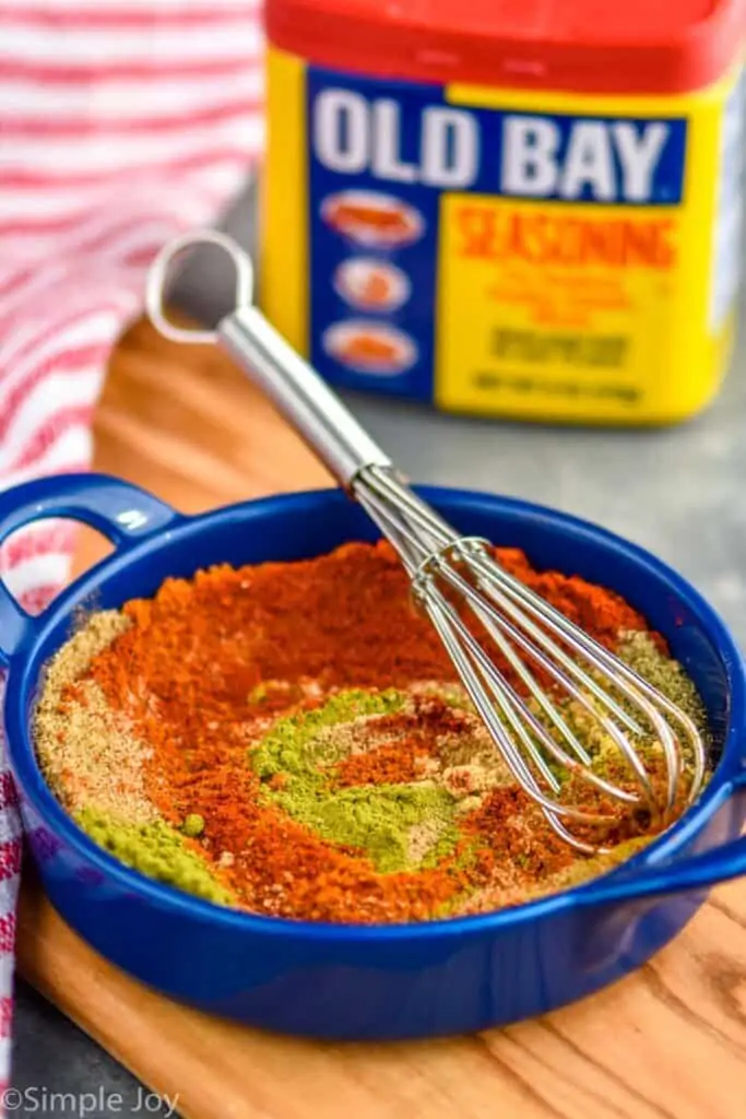 small blue dish with old bay seasoning substitute being mixed together with a small whisk