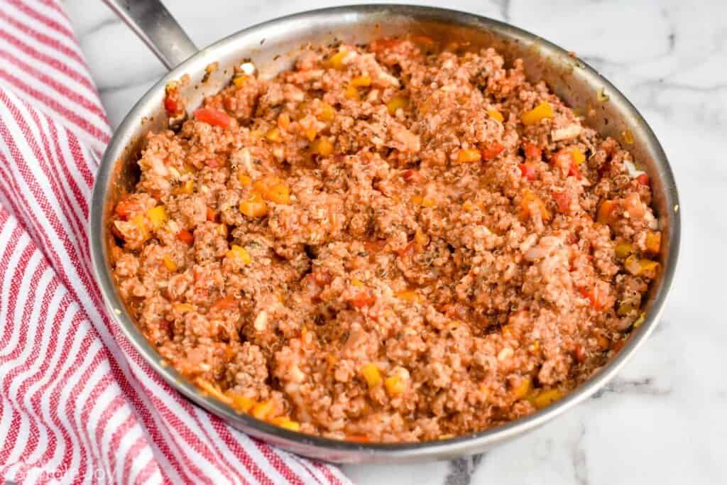 a skillet filled with stuffing for turkey quinoa stuffed peppers