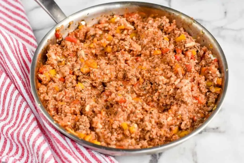 a skillet filled with stuffing for turkey quinoa stuffed peppers