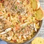 overhead of sun dried tomato pasta with chicken cut up on top of the pasta - 12