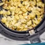 pinterest graphic of overhead of air fryer cauliflower in the air fryer basket