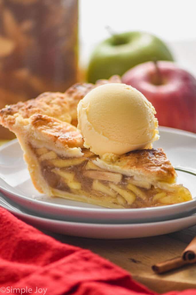 close up picture of a slice of apple pie made form easy apple pie filling topped with a scoop of vanilla ice cream