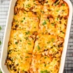 overhead of a chicken enchilada casserole in a baking dish - 17