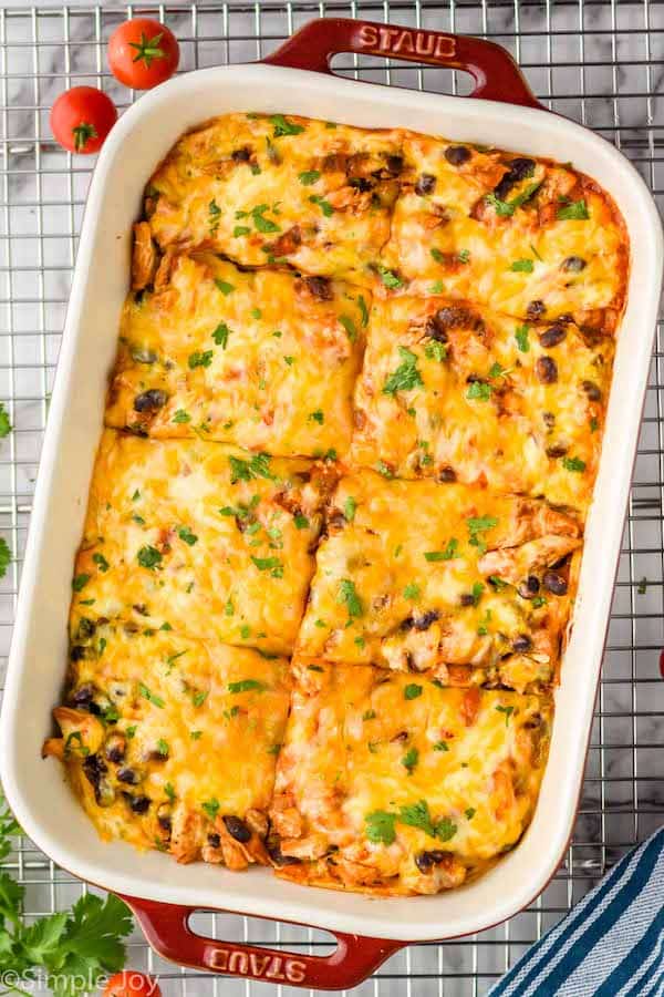 overhead of a chicken enchilada casserole in a baking dish