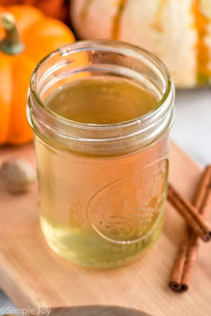 a mason jar full of homemade pumpkin spice syrup