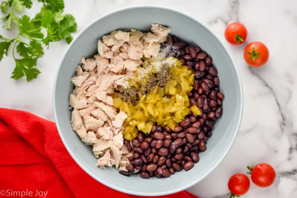 overhead of ingredients for a filling in a chicken enchilada casserole