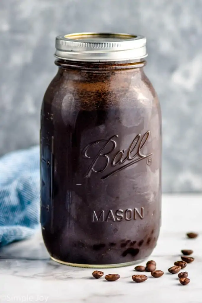 a mason jar full of water and ground coffee