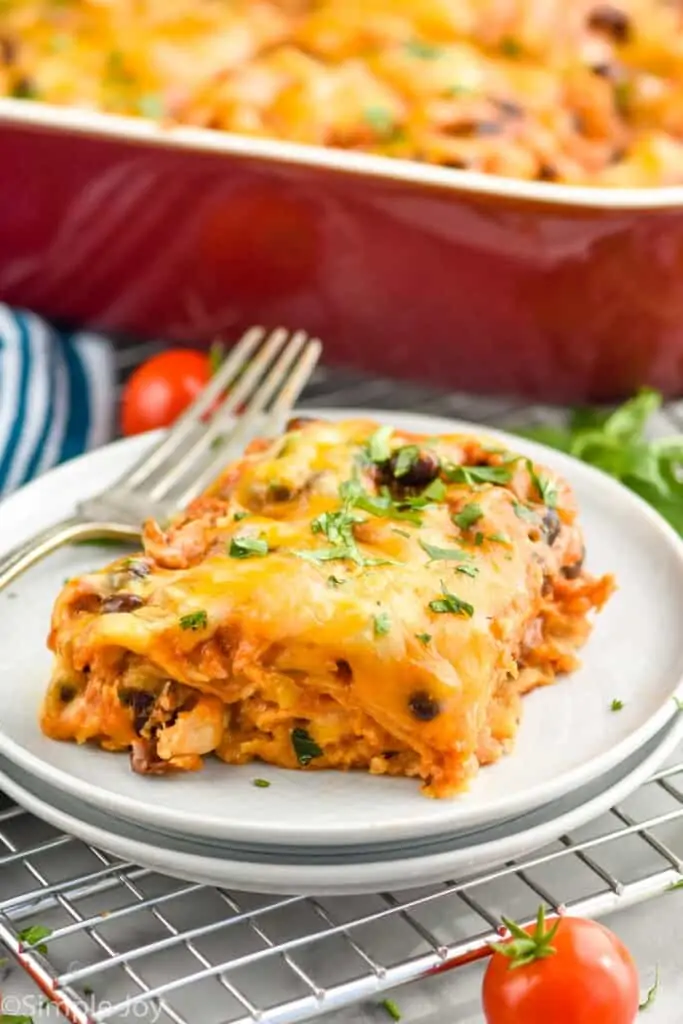 a pice of layered chicken enchilada casserole on a plate